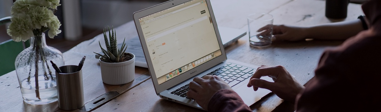 laptop on a desk with plants