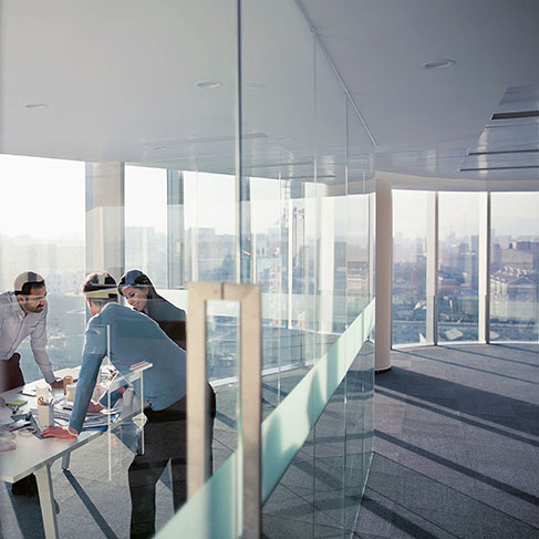 Group of diverse business people consulting at a conference table with city downtown in the background